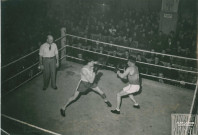 Combat de boxe sur un ring : photographie noir et blanc.