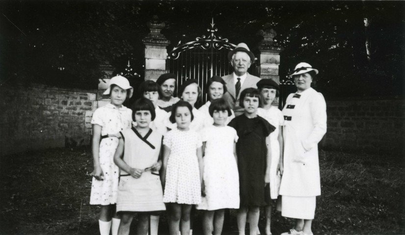 Colonies de vacances dans le nord du Morvan, groupe d'enfants posant avec le maire Charles Auray et son épouse à Arcenay : photographie noir et blanc.