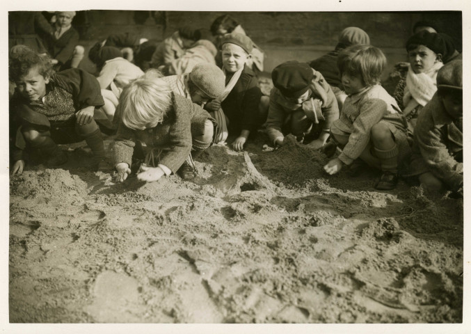 École maternelle de la route des Petits-Ponts, enfants jouant dans un bac à sable : photographie noir et blanc.