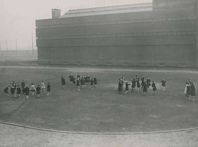 Jeunes filles jouant au ballon sur le stade Sadi-Carnot : photographie noir et blanc.