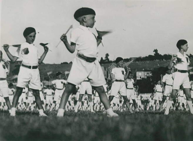 Fête d'éducation physique, mouvements d'ensemble avec des drapeaux : photographie noir et blanc.