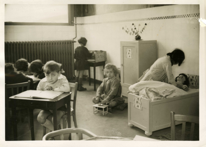 École maternelle de la route des Petits-Ponts, enfants dans une salle de classe : photographie noir et blanc.